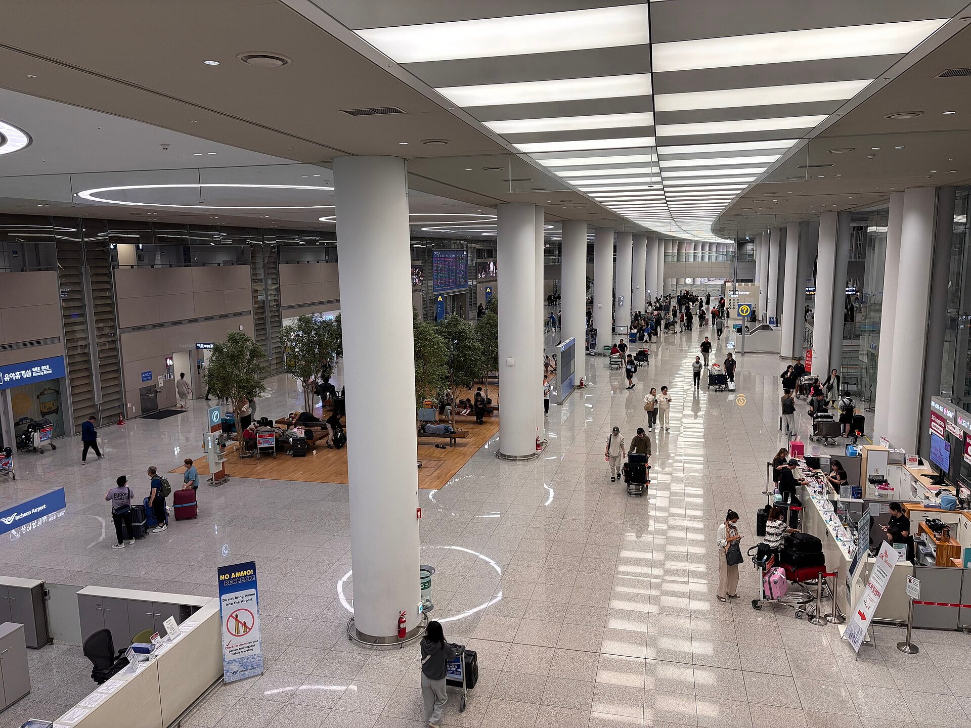 Travelers inside the Incheon International Airport terminal